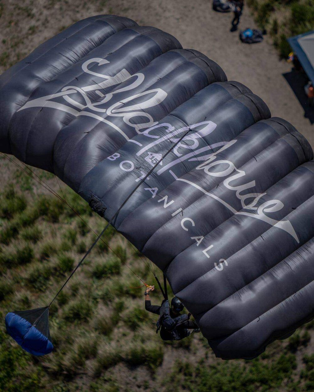 A Blackhouse Botanicals branded canopy over the landing zone